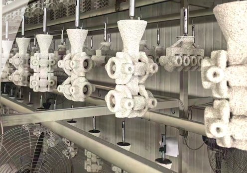 White ceramic shell molds on an automated shellbuilding line
